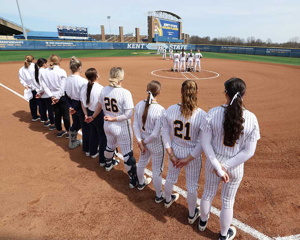 Team stands on the field at Devine Diamond