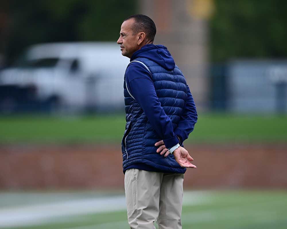 Coach watches the game