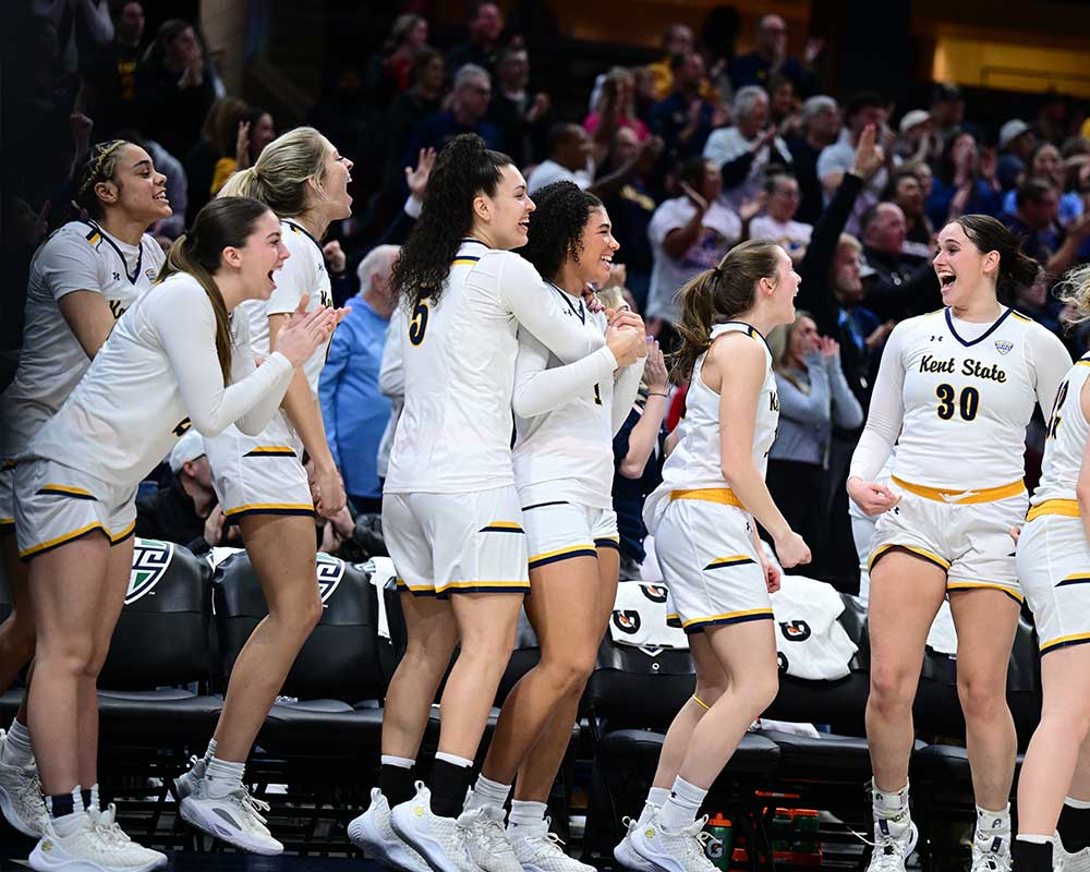 team members celebrating at women’s basketball game